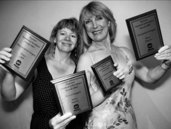 Helene and Rosie hold up the 4 plaques they won between them