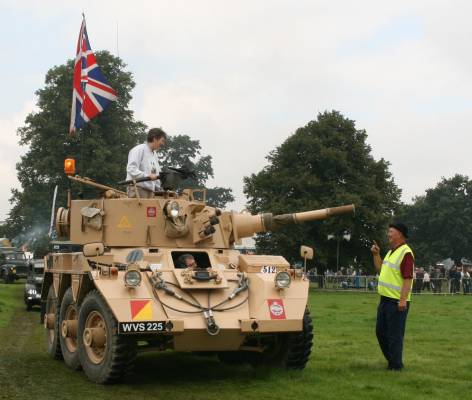 Image of a man addressing several people in a small tank.