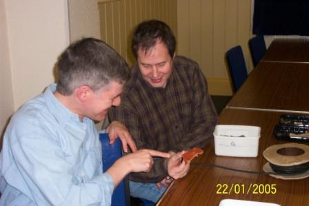 Picture of two people inspecting a piece of pottery