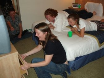 Picture of several Mensans abused by Claire's struggle with some dodgy hotel room furniture