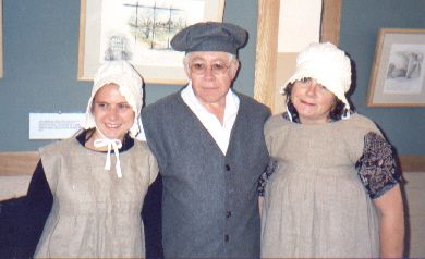 Picture of members dressed appropriately for working in the workhouse and of the period
